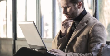 Man pondering a DPC membership on computer